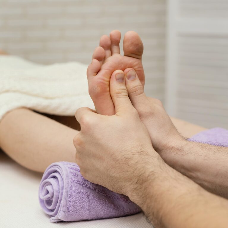 close up hands massaging sole